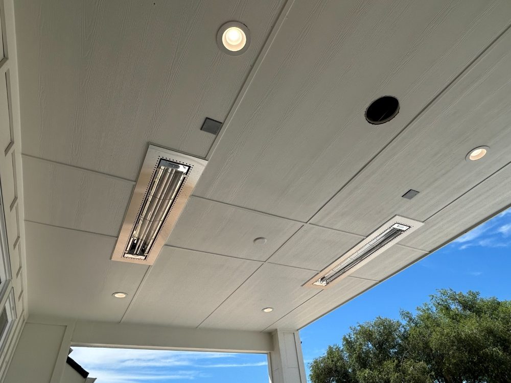 Recessed patio heaters and can lights in a covered patio ceiling