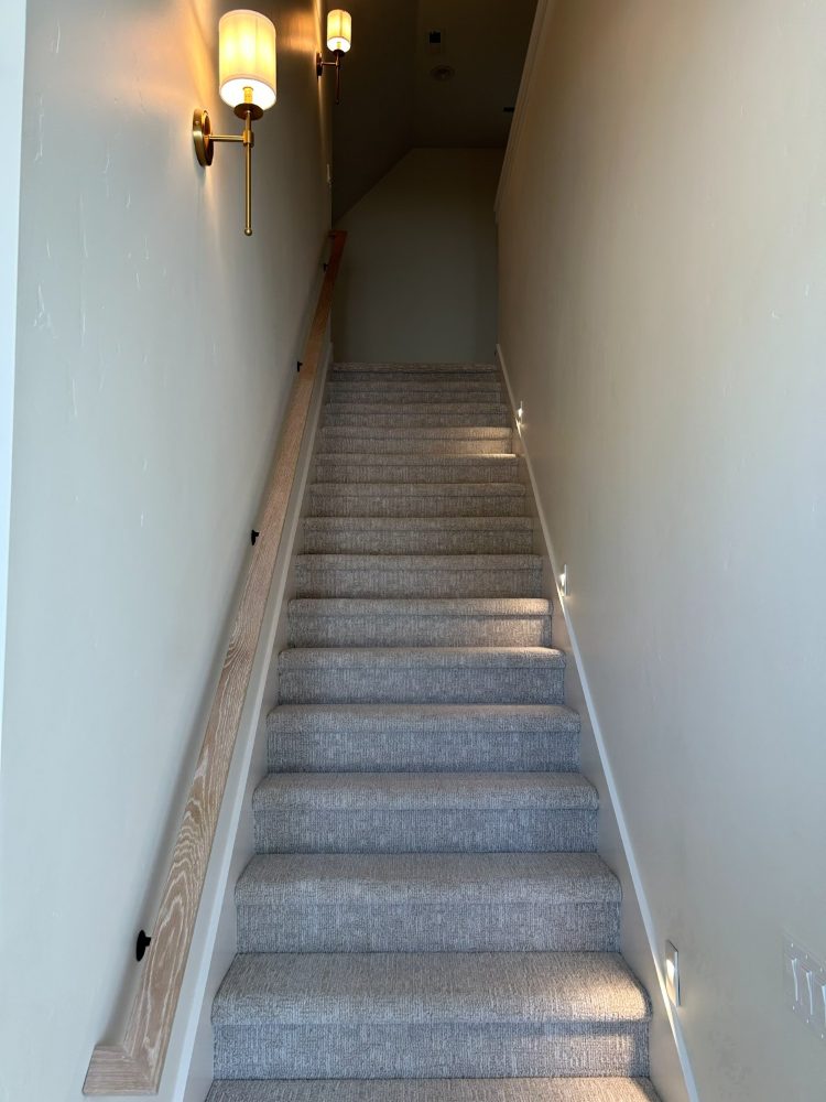 Stair lighting with recessed step lights and brass wall sconces