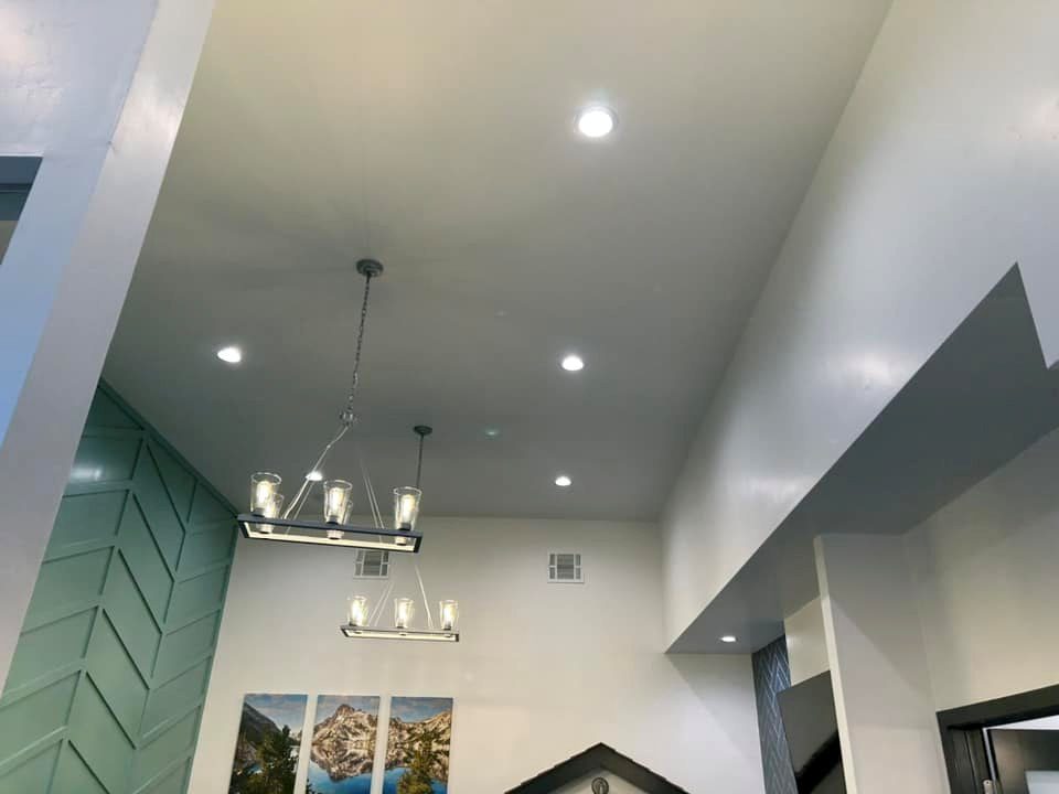 Reception area with pendant fixtures and recessed can lighting